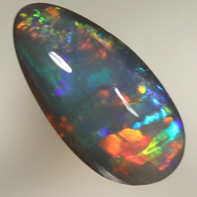 SOLID BLACK OPAL Bright rolling flashes over a medium high dome